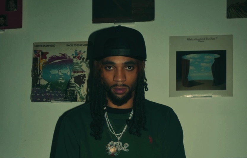 King Zeus in front of a wall of records